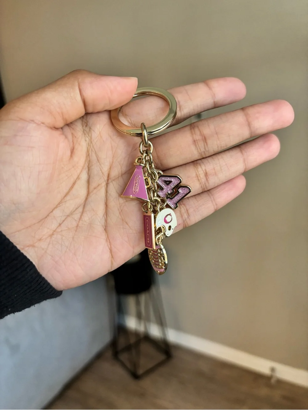 Coach Girly Football bag charm keychain in the champagne gold color
